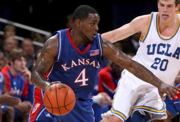 WESTWOOD, CA - DECEMBER 06:  Sherron Collins #4 of the Kansas Jayhawks drives around Michael Roll #20 of the UCLA Bruins on December 6, 2009 at Pauley Pavillion in Westwood, California.  Kansas won 73-61.  (Photo by Stephen Dunn/Getty Images)