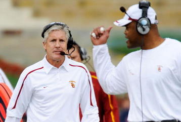 LOS ANGELES, CA - DECEMBER 05:  Coach Pete Carroll (L) of the USC Trojans talks with Ken Norton Jr., Assistant Head Coach of the Defense/Linebackers during the foruth quarter of the NCAA college football game against Arizona Wildcats at the Los Angeles Coliseum on December 5, 2009 in Los Angeles, California.  (Photo by Kevork Djansezian/Getty Images)
