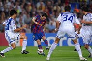 BARCELONA, SPAIN - SEPTEMBER 29: Lionel Messi (2nd L) of Barcelona scores his sides opening goal past Leandro Almeida (L), Yevgen Khacheridi (2nd R) and Ognjen Vukojevic of Dynamo Kiev during the Champions League group F match between Barcelona and Dynamo Kiev at the Camp Nou Stadium on September 29, 2009 in Barcelona, Spain. (Photo by Jasper Juinen/Getty Images)