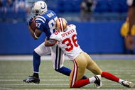 INDIANAPOLIS - NOVEMBER 01: Reggie Wayne #87 of the Indianapolis Colts is tackled by Shawntae Spencer #36 of the San Francisco 49ers during the NFL game at Lucas Oil Stadium on November 1, 2009 in Indianapolis, Indiana. The Colts won 18-14. (Photo by Andy Lyons/Getty Images)