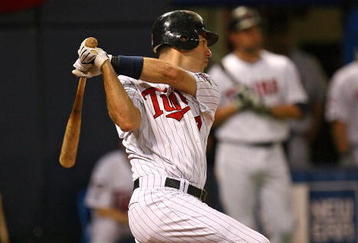 MINNEAPOLIS - OCTOBER 11: Joe Mauer #7 of the Minnesota Twins hits a run-scoring single in the 6th inning against the New York Yankees in Game Three of the ALDS during the 2009 MLB Playoffs at the Hubert H. Humphrey Metrodome on October 11, 2009 in Minneapolis, Minnesota. (Photo by Jonathan Daniel/Getty Images)