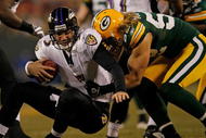 GREEN BAY, WI - DECEMBER 07: Clay Matthews #52 of the Green Bay Packers sacks Joe Flacco #5 of the Baltimore Ravens at Lambeau Field on December 7, 2009 in Green Bay, Wisconsin. The Packers defeated the Ravens 27-17. (Photo by Jonathan Daniel/Getty Images)