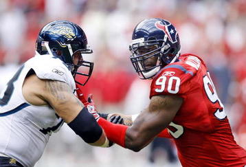 HOUSTON - SEPTEMBER 27:  Offensive tackle Jordan Black #78 of the Jacksonville Jaguars and defensive end Mario Williams #90 of the Houston Texans hook up at Reliant Stadium on September 27, 2009 in Houston, Texas.  (Photo by Bob Levey/Getty Images)