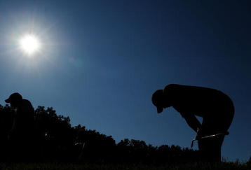 CHASKA, MN - AUGUST 16:  Tiger Woods (R) reacts to his tee shot on the 17th hole as caddie Steve Williams walks off during the final round of the 91st PGA Championship at Hazeltine National Golf Club on August 16, 2009 in Chaska, Minnesota.  (Photo by Stuart Franklin/Getty Images)