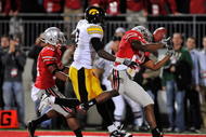COLUMBUS, OH - NOVEMBER 14: Defensive back Anderson Russell #21of the Ohio State Buckeyes intercepts a pass intended for Marvin McNutt #7 of the Iowa Hawkeyes in the end zone to stop Iowa's first overtime drive as Devon Torrence #10 of the Buckeyes trails the play at Ohio Stadium on November 14, 2009 in Columbus, Ohio. Ohio State defeated Iowa 27-24 in overtime. (Photo by Jamie Sabau/Getty Images)