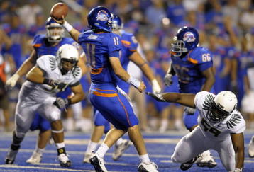 BOISE, ID - SEPTEMBER 3: Quarterback Kellen Moore #11 of the Boise State Broncos gets off a pass under the rush of Zac Clark #99 and Terrance Montgomery #59 of the Oregon Ducks in the fourth quarter of the game on September 3, 2009 at Bronco Stadium in Boise, Idaho. Boise State won the game 19-8. (Photo by Steve Dykes/Getty Images)