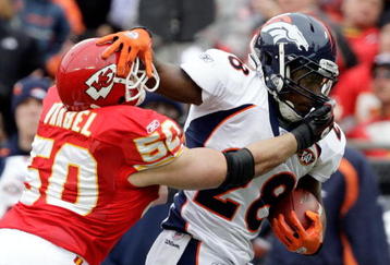 KANSAS CITY, MO - DECEMBER 06:  Correll Buckhalter #28 of the Denver carries the ball as Mike Vrabel #50 of the Kansas City Chiefs defends during the game on December 6, 2009 at Arrowhead Stadium in Kansas City, Missouri.  (Photo by Jamie Squire/Getty Images)