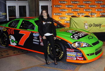 PHOENIX - DECEMBER 08: IndyCar driver Danica Patrick stands poses next to her new NASCAR during a press conference announcing her participation in the 2010 NASCAR season on December 8, 2009 in Phoenix, Arizona. Patrick's first NASCAR race will be February 6th in Daytona, Florida.  (Photo by Joshua Lott/Getty Images)