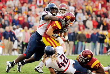 LOS ANGELES, CA - DECEMBER 05:  Quarterback Matt Barkley #7 of the USC Trojans is sacked by Earl Mitchell #49 and Brooks Reed #42 of the Arizona Wildcats during the fourth quarter of the NCAA college football game at the Los Angeles Coliseum on December 5, 2009 in Los Angeles, California.  (Photo by Kevork Djansezian/Getty Images)