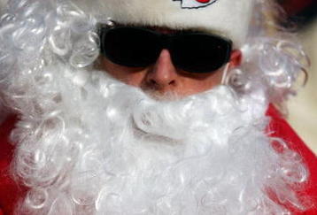 KANSAS CITY, MO - DECEMBER 21:  Santa Claus watches from the front row during the game between the Miami Dolphins and the Kansas City Chiefs on December 21, 2008 at Arrowhead Stadium in Kansas City, Missouri.  (Photo by Jamie Squire/Getty Images)