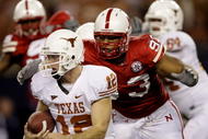 ARLINGTON, TX - DECEMBER 5:  Quarterback Colt McCoy #12 of the Texas Longhorns is sacked by Ndamukong Suh #93 of the Nebraska Cornhuskers in the first quarter of the game at Cowboys Stadium on December 5, 2009 in Arlington, Texas. (Photo by Jamie Squire/Getty Images)