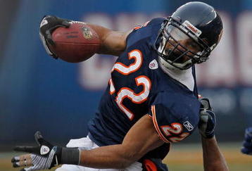 CHICAGO - DECEMBER 06: Matt Forte #22 of the Chicago Bears is brought down by an illegal 'horse-coillar' tackle by Paris Lenon #53 of the St. Louis Rams at Soldier Field on December 6, 2009 in Chicago, Illinois. The Bears defeated the Rams 17-9. (Photo by Jonathan Daniel/Getty Images)
