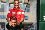 HOCKENHEIM, GERMANY - JULY 23: David Coulthard of Great Britain and Mclaren gives Michael Schumacher a piggy back after the practice session for the German F1 Grand Prix at the Hockenheim Circuit on July 23, 2004, in Hockenheim, Germany. (Photo by Clive Rose/Getty Images) 