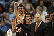 ANAHEIM, CA - DECEMBER 8: Carlin Hughes #3 and Omar Samhan #50 of the Saint Mary's College Gaels celebrate a 69-64 win along with Head Coach Randy Bennett over the San Diego State Aztecs during the second half for the John Wooden Classic at the Honda Center December 8, 2007 in Anaheim, California.  (Photo by Harry How/Getty Images)