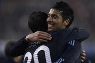 VALENCIA, SPAIN - DECEMBER 12:  Ezequiel Garay (R) of Real Madrid celebrates his goal with his teammate Gonzalo Higuain during the La Liga Match between Valencia and Real Madrid at Estadio Mestalla on December 12, 2009 in Valencia, Spain. Real Madrid won 3-2.  (Photo by Manuel Queimadelos Alonso/Getty Images)