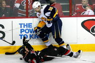RALEIGH, NC - FEBRUARY 26:  Rod Brind'Amour #17 of the Carolina Hurricanes is knocked to the ice after being hit by Patrick Kaleta #36 of the Buffalo Sabres during the game on February 26, 2009 at RBC Center in Raleigh, North Carolina.  (Photo by Kevin C. Cox/Getty Images)