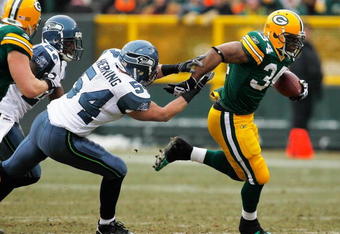 GREEN BAY, WI - DECEMBER 27: Ahman Green #34 of the Green Bay Packers breaks away from Will Herring #54 of the Seattle Seahawks at Lambeau Field on December 27, 2009 in Green Bay, Wisconsin. The Packers defeated the Seahawks 48-10.  (Photo by Jonathan Daniel/Getty Images)