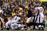 PITTSBURGH - DECEMBER 27: James Farrior #51 and Casey Hampton #98 signal Ike Taylor's fumble recovery for the Pittsburgh Steelers during the game against the Baltimore Ravens at Heinz Field on December 27, 2009 in Pittsburgh, Pennsylvania. (Photo by Karl Walter/Getty Images)