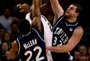 BOSTON - MARCH 26:  Brad Wanamaker #22 of the Pittsburgh Panthers fights for a rebound with Jamel McLean #22 and Joe Hughes #32 of the Xavier Musketeers during the NCAA Men's Basketball Tournament East Regionals at TD Banknorth Garden on March 26, 2009 in Boston, Massachusetts.  (Photo by Elsa/Getty Images)
