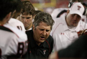 HOUSTON - SEPTEMBER 26: Head coach Mike Leach of the Texas Tech Red Raiders talks with his defense while playing against the University of Houston at Robertson Stadium on September 26, 2009 in Houston, Texas.  (Photo by Thomas B. Shea/Getty Images)