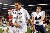 ARLINGTON, TX - SEPTEMBER 05:  Quarterback Sam Bradford #14 of the Oklahoma Sooners walks off the field past Jeremy Beal #44 after a 14-13 loss against the Brigham Young Cougars at Cowboys Stadium on September 5, 2009 in Arlington, Texas.  Bradford suffered an injury in the second quarter and did not return to the game.  (Photo by Ronald Martinez/Getty Images)