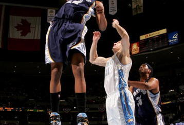 DENVER - APRIL 16:  Rudy Gay #22 of the Memphis Grizzlies collects a rebound and dunks it as Eduardo Najera #21 of the Denver Nuggets defends at the Pepsi Center on April 16, 2008 in Denver, Colorado. NOTE TO USER: User expressly acknowledges and agrees that, by downloading and or using this photograph, user is consenting to the term and conditions of the Getty Images License Agreement.  (Photo by Doug Pensinger/Getty Images)