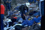 29 MAY 1985:  RESCUERS CHECK FOR SIGNS OF LIFE AMONGST THE BODIES LYING ON THE TERRACES OF THE HEYSEL STADIUM AFTER A WALL COLLAPSED KILLING 39 SUPPORTERS DURING A RIOT PRIOR TO THE EUROPEAN CUP FINAL. IN THE GAME WHICH WENT AHEAD ONLY BECAUSE POLICE FEARED FURTHER TROUBLE IF IT WAS POSTPONED JUVENTUS BEAT LIVERPOOL 1-0.
