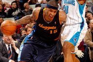 NEW ORLEANS - DECEMBER 18:  Carmelo Anthony #15 of the Denver Nuggets drives around David West #30 of the New Orleans Hornets at New Orleans Arena on December 18, 2009 in New Orleans, Louisiana.  The Hornets defeated the Nuggets 98-92.  NOTE TO USER: User expressly acknowledges and agrees that, by downloading and/or using this Photograph, User is consenting to the terms and conditions of the Getty Images License Agreement.  (Photo by Chris Graythen/Getty Images)