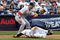 NEW YORK - SEPTEMBER 27:  Nick Swisher #33 of the New York Yankees slides into third base as Mike Lowell #25 waits for the ball of the Boston Red Sox on September 27, 2009 at Yankee Stadium in the Bronx borough of New York City.  (Photo by Jim McIsaac/Getty Images)