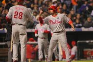 DENVER - OCTOBER 11: Shane Victorino #8 of the Philadelphia Phillies gestures 'hang loose' to teammate Jayson Werth #28 after Victorino scored in the top of the fourth inning against the Colorado Rockies in Game Three of the NLDS during the 2009 MLB Playoffs at Coors Field on October 11, 2009 in Denver, Colorado. (Photo by Doug Pensinger/Getty Images)