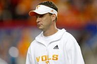 ATLANTA - DECEMBER 31: Coach Lane Kiffin of the Tennessee Volunteers watches pre-game warmups before the Chick-Fil-A Bowl against the Virginia Tech Hokies at the Georgia Dome on December 31, 2009 in Atlanta, Georgia. The Hokies beat the Volunteers 37-14. (Photo by Mike Zarrilli/Getty Images)