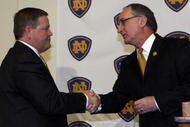 SOUTH BEND, IN - DECEMBER 11: Notre Dame atheletic director Jack Swarbrick (R) greets Brian Kelly as he is introduced as the new football head coach at Notre Dame University on December 11, 2009 in South Bend, Indiana.  Kelly most recently led the University of Cincinnati to two consecutive Bowl Championship Series appearances including a perfect 12-0 record this past season. (Photo by Frank Polich/Getty Images)
