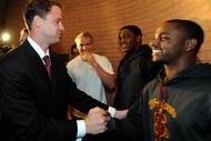 LOS ANGELES, CA - JANUARY 13:  Lane Kiffin (L)  the new college football coach of University of Southern California greets wide receiver Travon Patterson (R) as line backer Devon Kenard (2nd R) and quarterback Matt Barkley look on upon Kiffin's arrival at Heritage Hall on the campus of USC for a news conference on January 13, 2010 in Los Angeles, California.  (Photo by Kevork Djansezian/Getty Images)