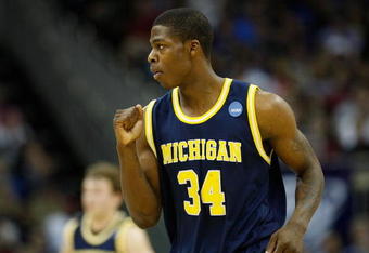KANSAS CITY, MO - MARCH 21:   DeShawn Sims #34 of the Michigan Wolverines pumps his fist after a scoring play in the first half against the Oklahoma Sooners during the second round of the NCAA Division I Men's Basketball Tournament at the Sprint Center on March 21, 2009 in Kansas City, Missouri.  (Photo by Jamie Squire/Getty Images)