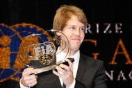 MONACO - DECEMBER 11:  In this handout image provided by FIA, driver Sebastian Vettel of Germany poses with his FIA trophy during the 2009 FIA Gala Prize Giving Ceremony held at the Salle des Etoiles Sporting Club on December 11, 2009 in Monte-Carlo, Monaco.  (Photo by FIA via Getty Images)