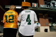GREEN BAY, WI - AUGUST 11: Fans of Aaron Rogers along with a Brett Favre fan wear their respective jerseys as the enter Lambeau Field prior to the game between the Green Bay Packers against the Cincinnati Bengals at the Lambeau Field on August 11, 2008 in Green Bay, Wisconsin. (Photo by Scott Boehm/Getty Images)