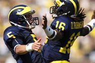 ANN ARBOR, MI - SEPTEMBER 05: Tate Forcier #5 of the Michigan Wolverines celebrates with Denard Robinson #16 after Robinson ran for a long first quarter touchdown against the Western Michigan Broncos on September 5, 2009 at Michigan Stadium in Ann Arbor, Michigan. (Photo by Gregory Shamus/Getty Images)