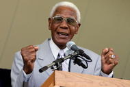 COOPERSTOWN, NY - JULY 30:  Former Negro League player John 'Buck' O'Neil speaks at Clark Sports Center during the Baseball Hall of Fame induction ceremony on July 30, 2006 in Cooperstown, New York.  (Photo by Jim McIsaac/Getty Images)