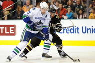 DALLAS - NOVEMBER 06: Henrik Sedin #33 of the Vancouver Canucks skates the puck past Trevor Daley #6 of the Dallas Stars at American Airlines Center on November 6, 2009 in Dallas, Texas. (Photo by Ronald Martinez/Getty Images)