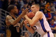 LAWRENCE, KS - JANUARY 25:  Zaire Taylor #11 of the Missouri Tigers wrestles for a loose ball with Cole Aldrich #45 of the Kansas Jayhawks during the game on January 25, 2010 at Allen Fieldhouse in Lawrence, Kansas.  (Photo by Jamie Squire/Getty Images)