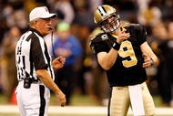NEW ORLEANS - JANUARY 16: Quarterback Drew Brees #9 of the New Orleans Saints talks with referee Ron Winter #14 against the Arizona Cardinals during the NFC Divisional Playoff Game at Louisana Superdome on January 16, 2010 in New Orleans, Louisiana. The Saints won 45-14. (Photo by Ronald Martinez/Getty Images)
