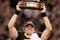NEW ORLEANS - JANUARY 24:  Drew Brees #9 of the New Orleans Saints celebrates with the George S. Halas Trophy after the Saints won 31-28 in overtime against the Minnesota Vikings during the NFC Championship Game at the Louisiana Superdome on January 24, 2010 in New Orleans, Louisiana.  (Photo by Jed Jacobsohn/Getty Images)