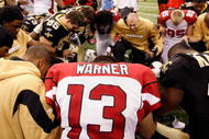 NEW ORLEANS - JANUARY 16:  Kurt Warner #13 of the Arizona Cardinals kneels and prays with players from both the Cardinals and the New Orleans Saints after the Saints won 45-14 during the NFC Divisional Playoff Game at Louisana Superdome on January 16, 2010 in New Orleans, Louisiana.  (Photo by Ronald Martinez/Getty Images)