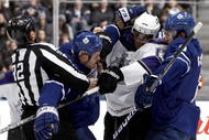 TORONTO - JANUARY 26: Ian White #7 and Luke Schenn #2 of the Toronto Maple Leafs rough up Wayne Simmonds #17 of the Los Angeles Kings during game action January 26, 2010 at the Air Canada Centre in Toronto, Ontario, Canada. (Photo by Abelimages / Getty Images)