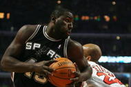 CHICAGO - OCTOBER 29:  DeJuan Blair #45 of the San Antonio Spurs moves the ball against Taj Gibson #22 of the Chicago Bulls during the game at United Center on October 29, 2009 in Chicago, Illinois. NOTE TO USER: User expressly acknowledges and agrees that, by downloading and/or using this Photograph, user is consenting to the terms and conditions of the Getty Images License Agreement. (Photo by Jonathan Daniel/Getty Images)