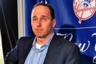 TAMPA - FEBRUARY 17:  General Manager Brian Cashman listens during a press conference with infielder Alex Rodriguez of the New York Yankees February 17, 2008 at the George M. Steinbrenner Field in Tampa, Florida. The Yankees third baseman admitted to taking a substance known as 'boli' acquired with his cousin in the Dominican Republic in 2001.  (Photo by Al Messerschmidt/Getty Images)