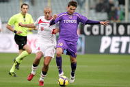FLORENCE, ITALY - JANUARY 10:  Adrian Mutu of ACF Fiorentina (R) in action against Sergio Bernardo Almiron (L) during the Serie A match between Fiorentina and Bari at Stadio Artemio Franchi on January 10, 2010 in Florence, Italy.  (Photo by Gabriele Maltinti/Getty Images)