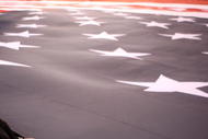 INDIANAPOLIS - JANUARY 16:  A soldier holds the United States flag on the field during the national anthem before the Indianapolis Colts take on the Baltimore Ravens in the AFC Divisional Playoff Game at Lucas Oli Stadium on January 16, 2010 in Indianapolis, Indiana.  (Photo by Jonathan Daniel/Getty Images)