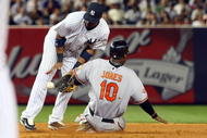 NEW YORK - JULY 20: Adam Jones #10 of the Baltimore Orioles steals second base against Robinson Cano #24 of the New York Yankees on July 20, 2009 at Yankee Stadium in the Bronx borough of New York City. The Yankees defeated the Orioles 2-1. (Photo by Jim McIsaac/Getty Images)