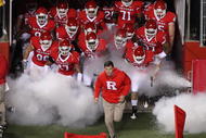 PISCATAWAY, NJ - NOVEMBER 12:  Head coach Greg Schiano of the Rutgers Scarlet Knights leads his team on the field to play against the South Florida Bulls at Rutgers Stadium on November 12, 2009 in Piscataway, New Jersey.  (Photo by Jim McIsaac/Getty Images)